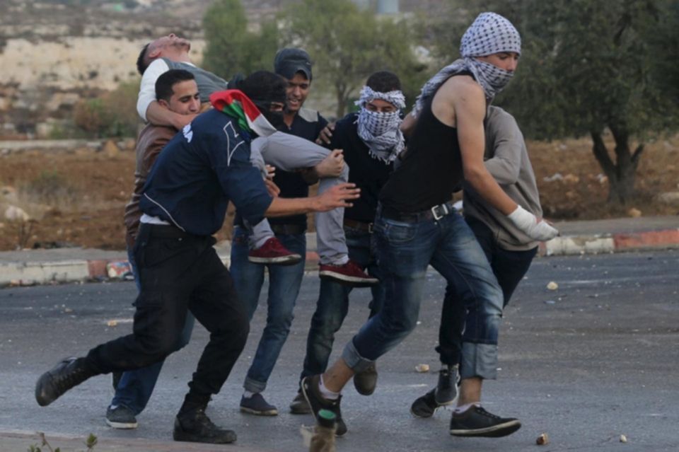 Young Palestinians carry a protester wounded in clashes with Israeli troops near the Jewish settlement of Bet El near Ramallah October 8 2015. Mohamad Torokman Reuters